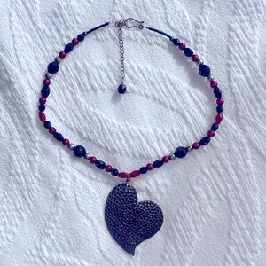 Heart necklace with red, black and beads.